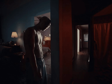 A man presses his head against a doorframe in Get Me Out